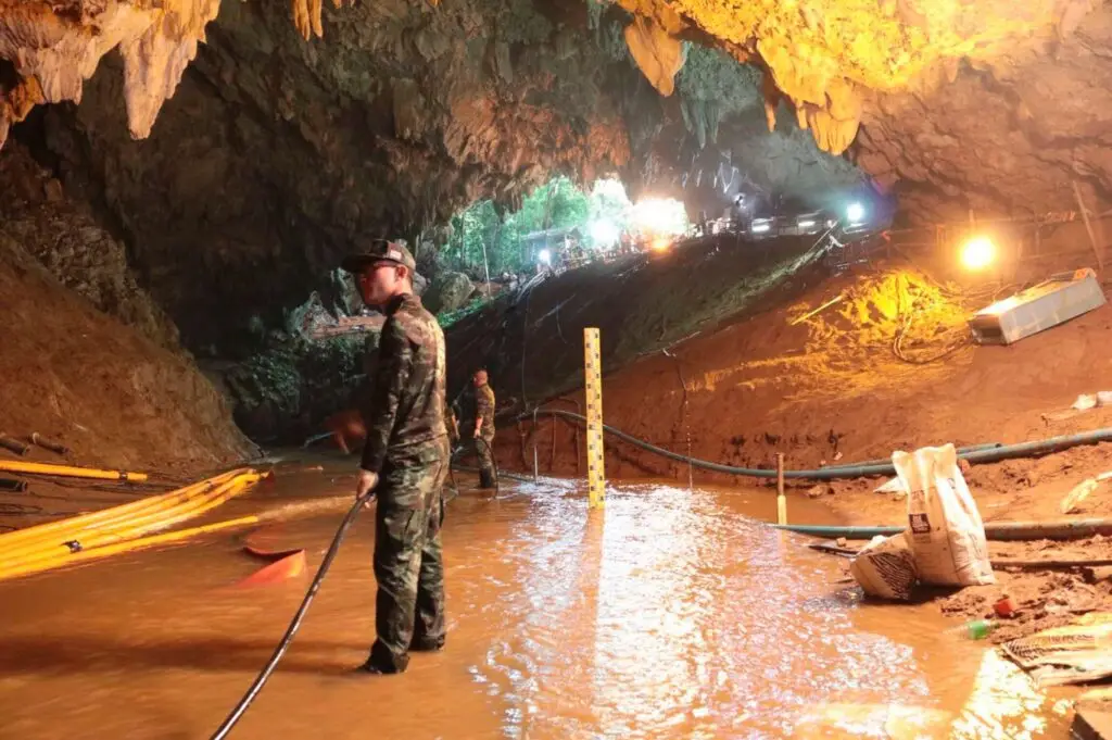 Thai rescue teams arrange a water pumping system at the entrance to a flooded cave complex where 12 boys and their soccer coach have been trapped since June 23, in Mae Sai, Chiang Rai province, northern Thailand in this undated photo released by Royal Thai Navy, July 7, 2018. Royal Thai Navy via AP